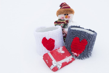 Snowman, gifts on the white snow.