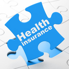 Insurance concept: Health Insurance on puzzle background