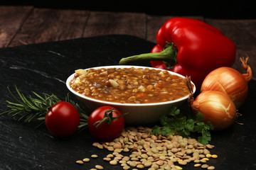 
Lentil soup with pita bread in a bowl on a wooden background