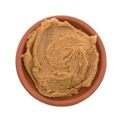 Cookie butter in a bowl top view isolated on a white background.