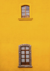 Fototapeta na wymiar Bright Yellow Wall Windows San Miguel de Allende Mexico