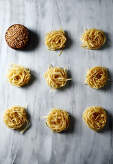 raw rolls of Italian tagliatelle noodles with wheat