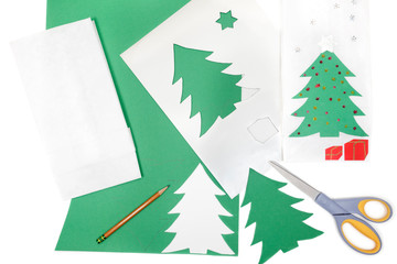 Construction paper, card, and stencils to make Christmas greeting card