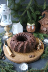 Chocolate cake with caramel and spices on rustic background for winter recreation. Christmas and New Year decorations