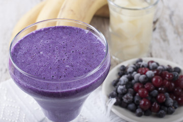 Smoothie of banana, canned pineapple, frozen cranberries and blueberries with yogurt 