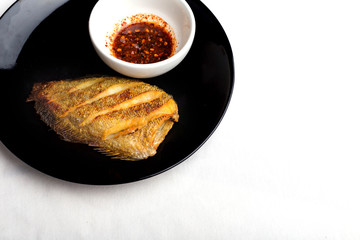 fish fry on black plate ,Trichogaster pectoralis, fish salid.