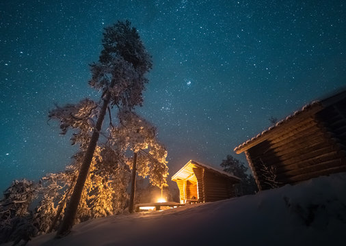 Night sky over hut and campfire