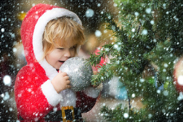 santa boy with decorated tree