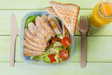 Lunch box with salad and chicken