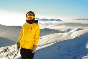 Fototapeta na wymiar girl in snowboard equipment against the backdrop of snow-capped
