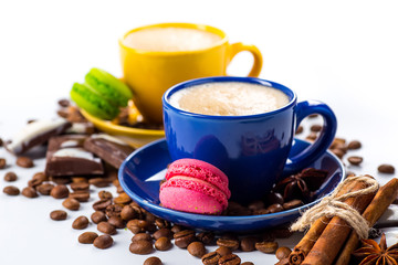 Cup of coffee and beans with delicious macaroon on a white backg