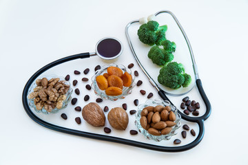 Food in the heart of a stethoscope on a white background. The concept of a healthy heart