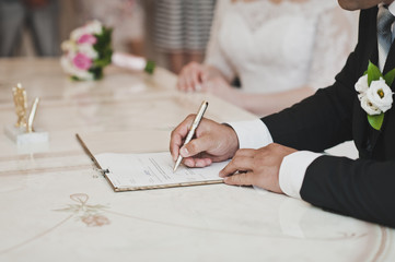 Male hand signing a document 6813.