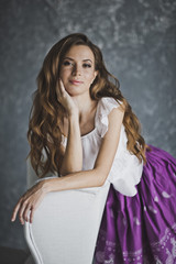 Fototapeta premium The girl leaned a hand on the white chair 6925.