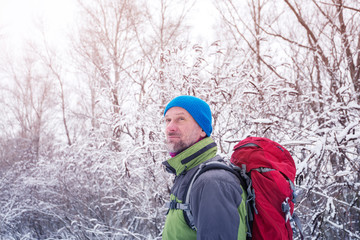 Fototapeta na wymiar Hiker relaxing in the winter forest