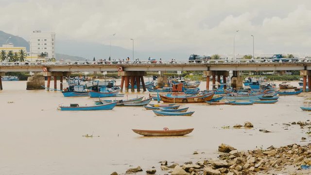 Long bridge in Nha Trang, central Vietnam. Bay with ships and boats.