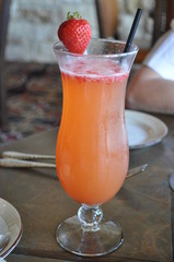 Tastey Glass Of Sangria Strawberry Bellini With A Straw Cup On The Table