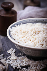 White uncooked rice on concrete background