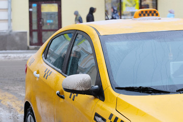 Moscow, Russia, December, 8, 2016: Close up image of .snow-covered Moscow yellow taxi