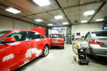 Fototapeta na wymiar Crashed cars in a car repair station