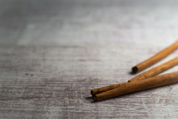 Cinnamon on wooden background. Macro photography.