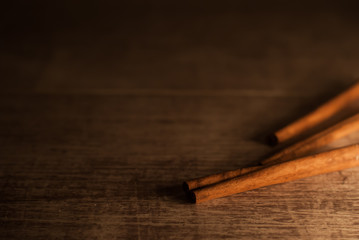 Cinnamon on wooden background. Macro photography.