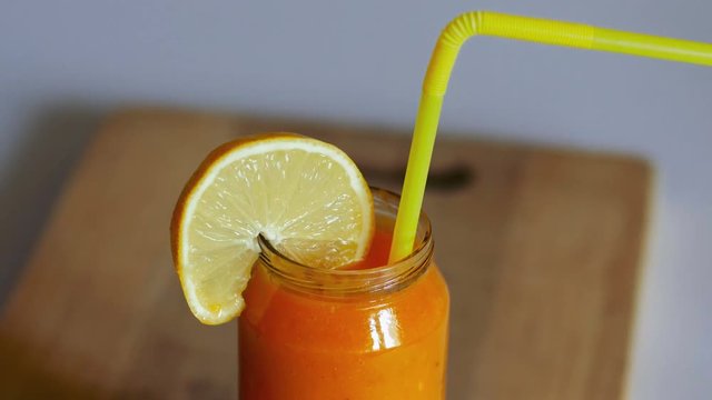 Orange smoothie on wooden background, healthly lifestyle concept. Close up