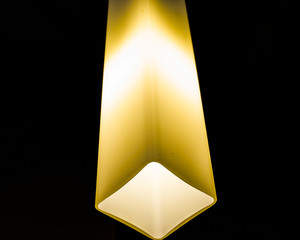 Glowing lamp on black background