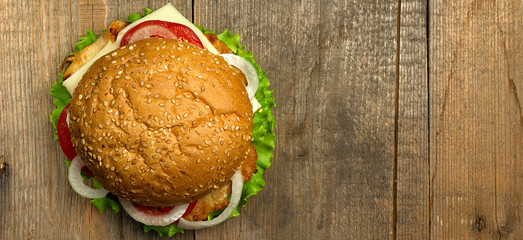 Top view gourmet  hamburger on wooden background. Fastfood meal, border design panoramic banner