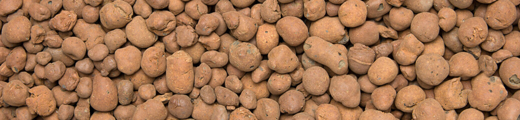 Heat expanded clay pebbles used as a growing media in hydroponics. Background close up of pellets,...
