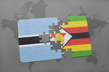 puzzle with the national flag of botswana and zimbabwe on a world map