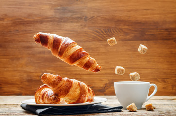 Flying croissant with coffee