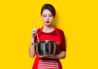 young housewife with pan and spoon