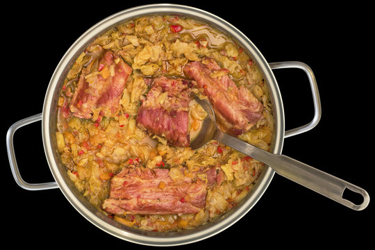 Cabbage Cooked with Smoked Pork Ribs Served in Stainless Steel Saucepot Isolated on Black Background