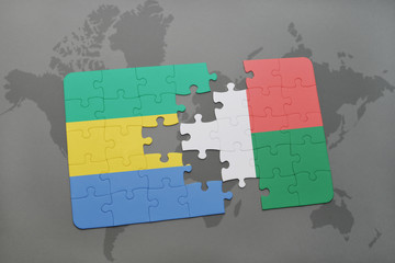 puzzle with the national flag of gabon and madagascar on a world map