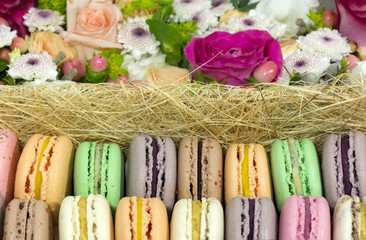 macaron cakes, cookies with different fruit fillings, flowers, r