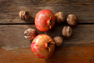 Still life. Pomegranate and nuts on a wooden table