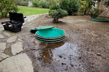 Septic system problems - Opening the lids to investigate leaks around a septic system's tanks & pump chamber