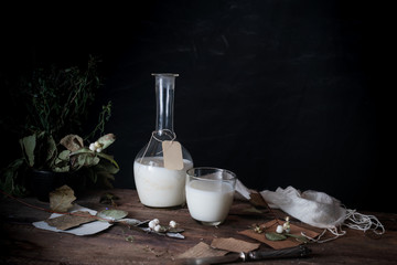 still life. vintage. a simple country breakfast on wooden table. milk, bread, eggs. black background