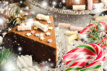 Traditional Homemade chocolate Christmas cake with sugar stars and marshmallow, new year decoration