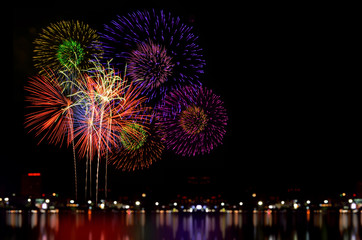 Fototapeta premium Fireworks celebration and the city night light background.