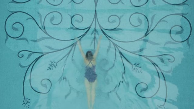 Woman floating in the swimming pool.