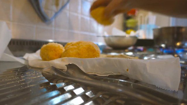 Home cooking of italian traditional dish arancini and meat