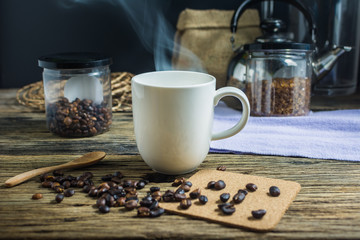 Focus spot, Cup of hot coffee on the old wooden table. In the morning coffee in the kitchen. Welcome the new day.