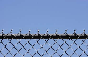 chainlink fence against blue sky