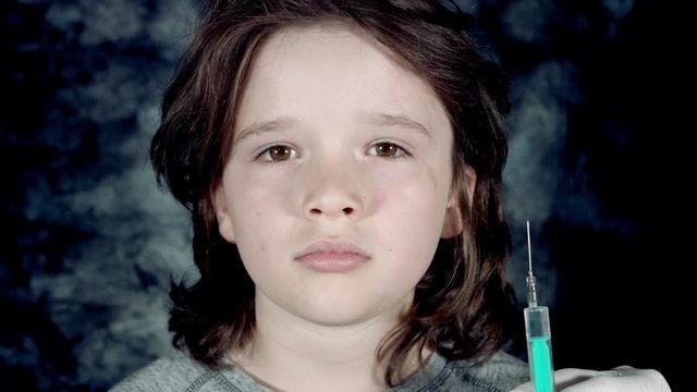 4k Dramatic Shot of a Sick Child and Doctor Hand Holding Injection