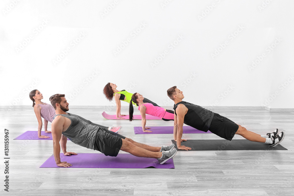 Sticker Group of people doing yoga exercises  in gym