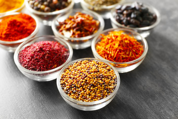 Various spices in glass bowls, closeup