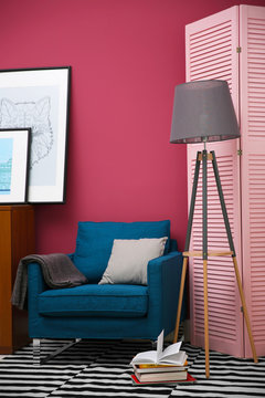 Blue armchair in stylish interior