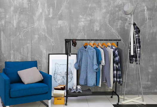 Casual stylish male shirts on hanger stand in room